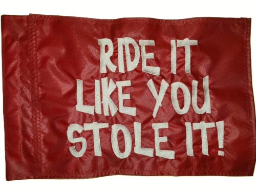 Ride it like you stole it safety flag made by Devil Woman Flags with dense embroidered white "RIDE IT LIKE YOU STOLE IT!" text graphic on red nylon rectangle with whip sleeve