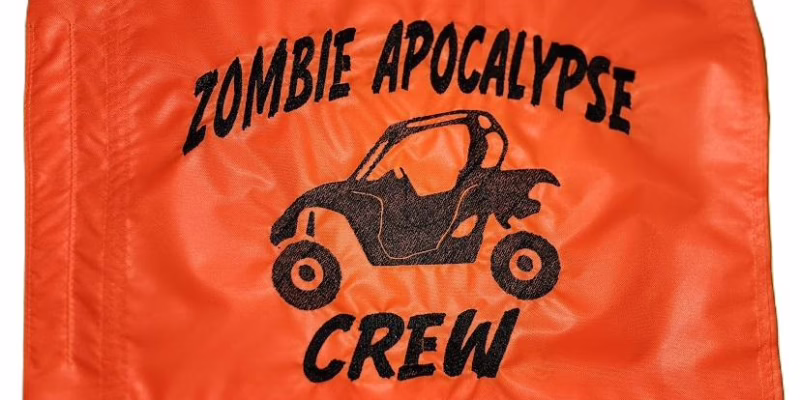 : Zombie Apocalypse Crew safety flag with dense embroidered black UTV silhouette and text on orange nylon rectangle with whip sleeve