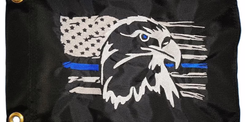 Thin Blue Line Eagle safety flag with embroidered bald eagle, tattered American flag, and vibrant blue line on black nylon rectangle