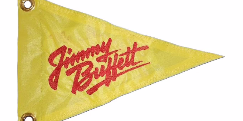 Jimmy Buffett safety flag with dense embroidered red script logo on yellow nylon pennant with solid brass grommets