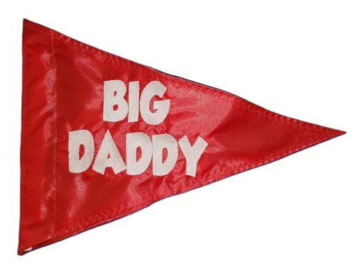 Big daddy safety flag made by Devil Woman Flags with dense embroidered white "BIG DADDY" text graphic on red nylon triangular pennant with whip sleeve.
