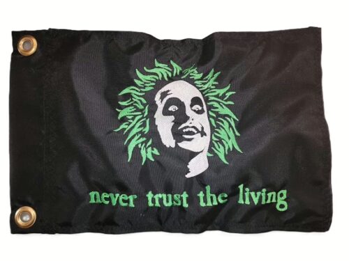 Beetlejuice safety flag with dense embroidered green hair ghost portrait and Never Trust the Living text on nylon rectangle with brass grommets