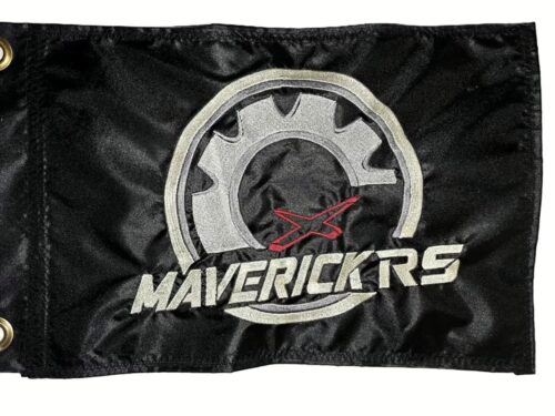 Can-Am Maverick RS safety flag with embroidered silver gear, red X, and Ivory Maverick RS lettering on black nylon rectangle with brass grommets