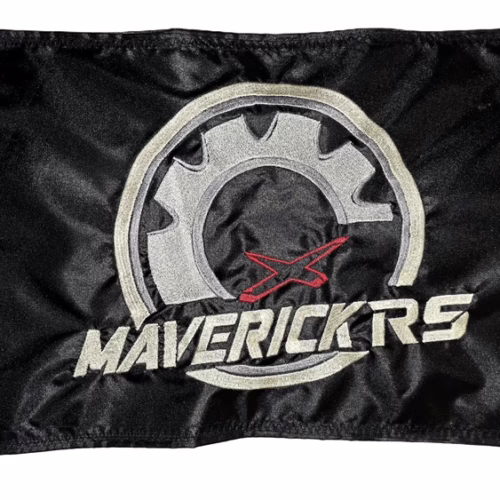 Can-Am Maverick RS safety flag with embroidered silver gear, red X, and Ivory Maverick RS lettering on black nylon rectangle with brass grommets