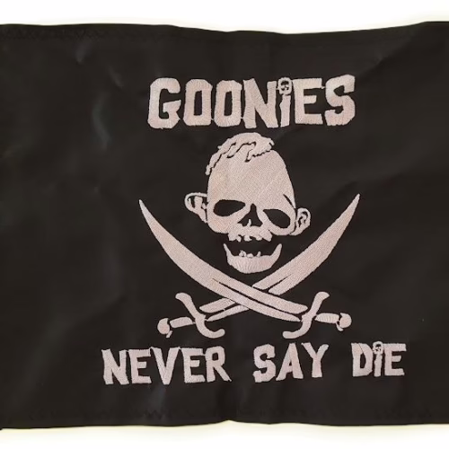 Sloth Never Say Die safety flag with dense embroidered silver skull emblem, crossed cutlasses, and custom movie text on black nylon rectangle with solid brass grommets