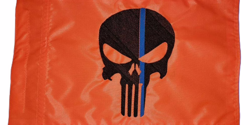 Thin Blue Line Punisher safety flag with black embroidered skull and royal blue line on orange nylon rectangle