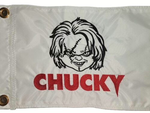 Chucky safety flag with dense embroidered scarred doll face and red Chucky text on nylon rectangle with brass grommets