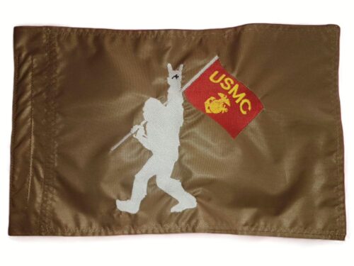 Bigfoot USMC safety flag with embroidered silhouette holding Marine Corps banner on coyote tan nylon rectangle with whip sleeve