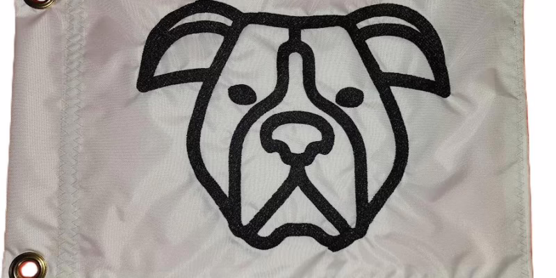 Boxer dog safety flag with dense embroidered black boxer head outline on white nylon rectangle with solid brass grommets