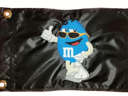 Cool M&M candy safety flag with dense embroidered mascot wearing sunglasses on nylon rectangle with brass grommets