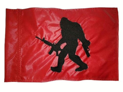 Tactical Bigfoot safety flag with embroidered black armed Sasquatch carrying rifle on red nylon rectangle with whip sleeve