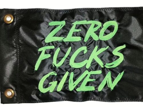 Zero Fucks Given safety flag with fluorescent lime green embroidered brush lettering on black nylon rectangle