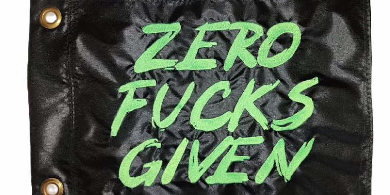 Zero Fucks Given safety flag with fluorescent lime green embroidered brush lettering on black nylon rectangle