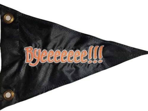 Byeeeeeeee safety flag made by Devil Woman Flags with dense embroidered orange "Byeeeeeeee!!!" text graphic on black nylon triangular pennant with solid brass grommets