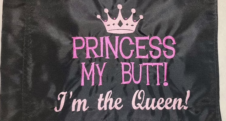 Princess My Butt I'm the Queen safety flag with pink embroidered crown and lettering on black nylon rectangle