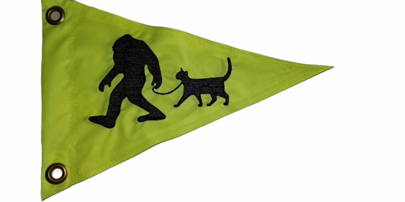 Bigfoot walking cat safety flag with embroidered black silhouette on lime squeeze green nylon pennant with brass grommets