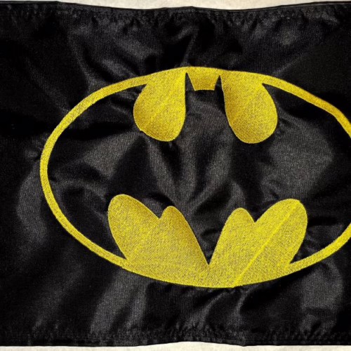Batman safety flag with embroidered yellow bat emblem on black nylon rectangle with whip sleeve
