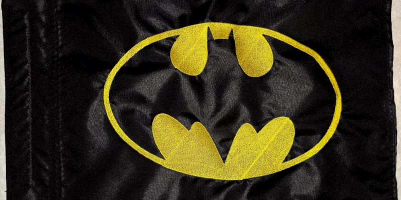 Batman safety flag with embroidered yellow bat emblem on black nylon rectangle with whip sleeve